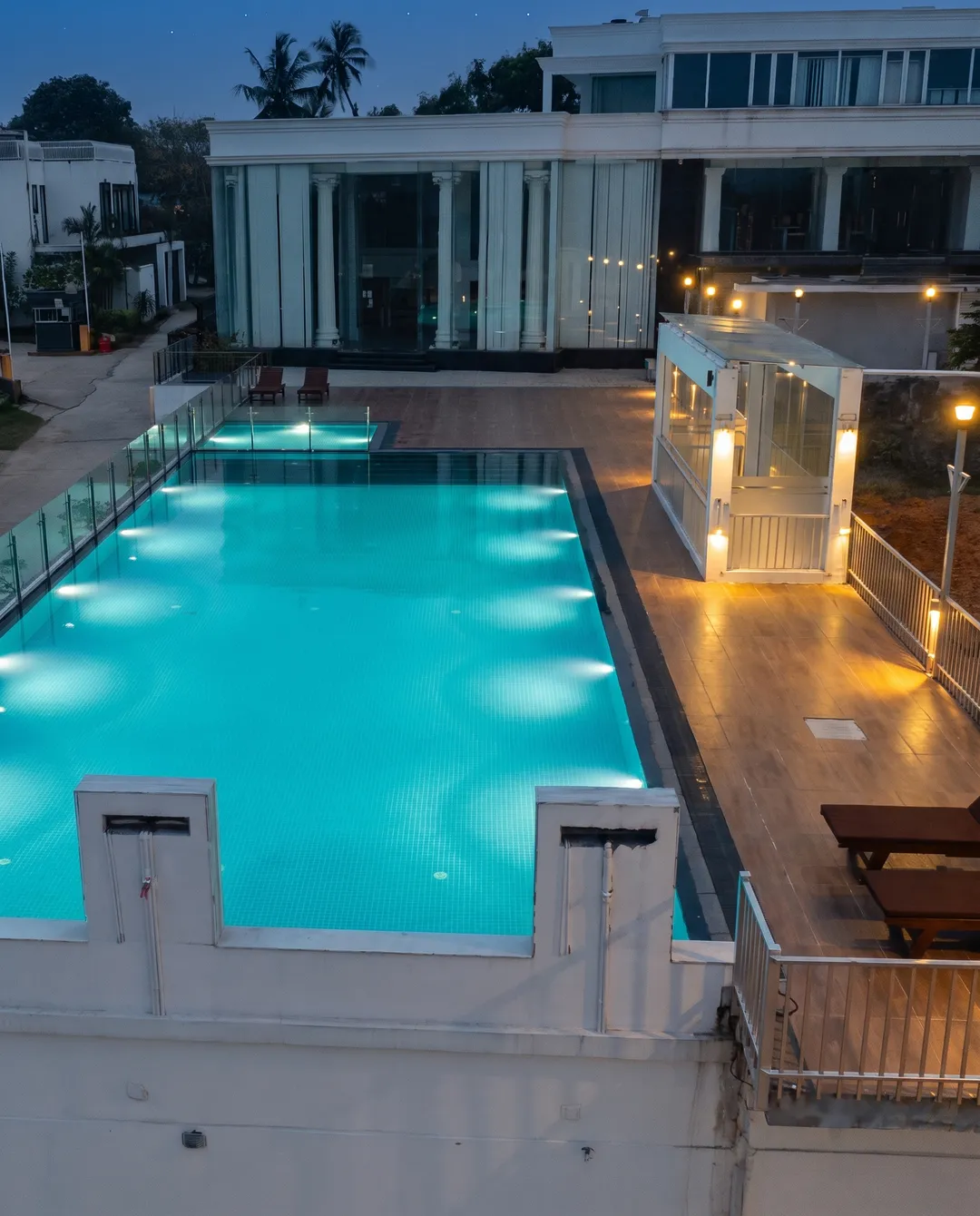 The OSMO pool at night, lit from below, beside the house