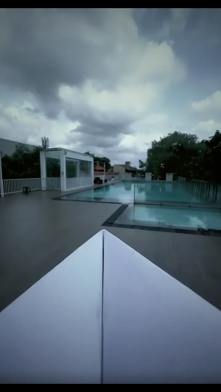 A paper plane's view flying over the OSMO pool, through the doors, and on through the halls of the estate